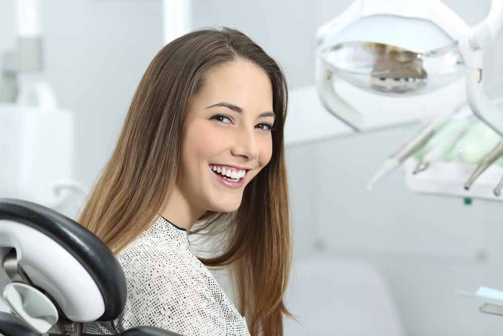 patient smiling after her porcelain veneers were placed