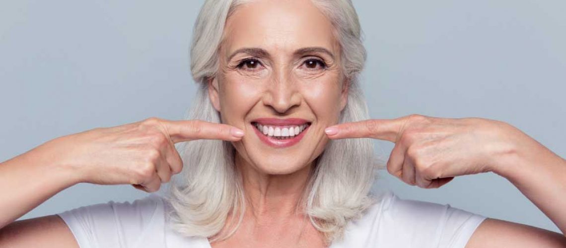 patient smiling after her all on 4 dental implant procedure