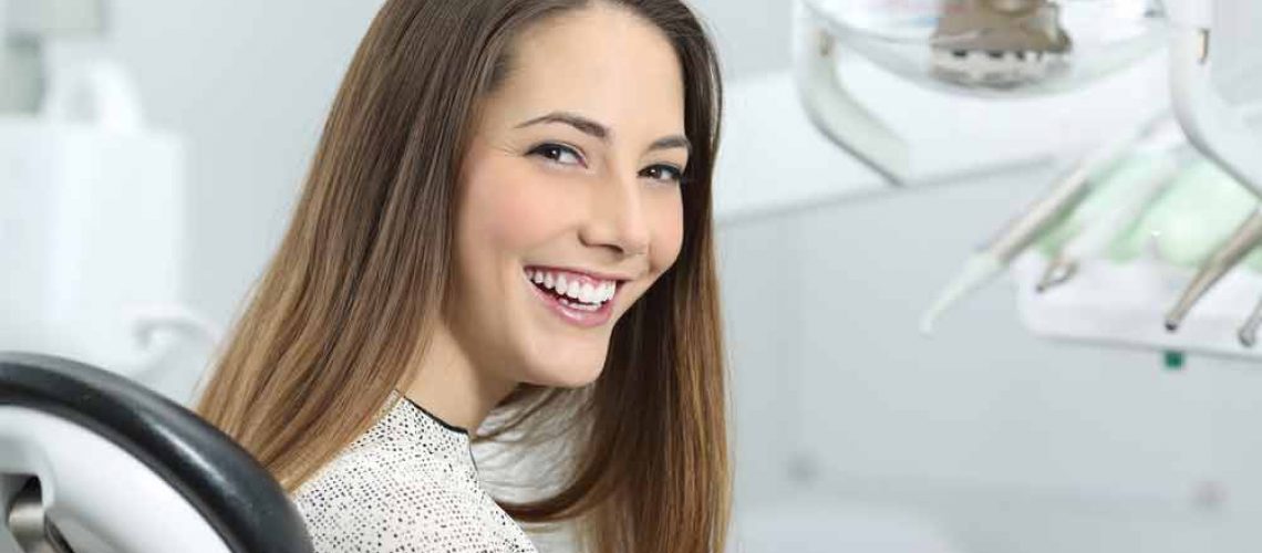 patient smiling after her porcelain veneers were placed